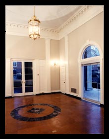 Renovated entry hall for the Albemarle County Historical Society in Charlottesville, Virginia with new cork flooring and doors, designed by architect Candace Smith, AIA