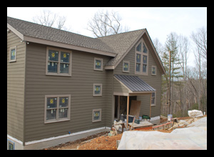 Contemporary new residence under construction in Albemarle County, Virginia, with custom windows at stair well and open A-frame roof at loft and great room, designed by Candace M.P. Smith Architect