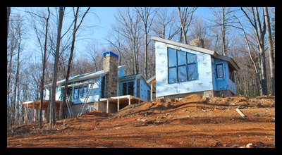 Modern new residence under construction in Albemarle County, Virginia, with outdoor fireplace and mountain views, designed by Candace Smith Architect