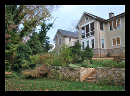 Additions to residence in Charlottesville, Virginia, include screened porch with vaulted, beadboard ceiling and Azek tongue-and-groove deck beyond, adjacent to new great room and master suite, with new stucco walls and stone veneer foundation, designed by Candace M.P. Smith Architect