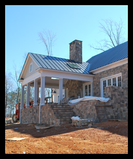 New residence under construction in Albemarle County, Virginia, with fieldstone and custom rear porch and outdoor fireplace, designed by Candace Smith Architect