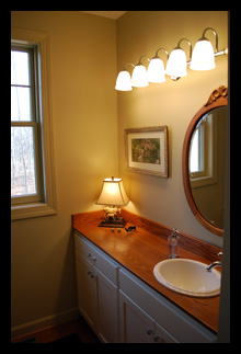 Custom vanity with natural wood counter for guest bath addition for residence in Virginia designed by Candace M.P. Smith Architect