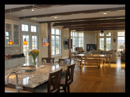 Open kitchen and great room with wood beam ceiling and transoms at new residence in Lexington, Virginia, by Candace Smith, AIA